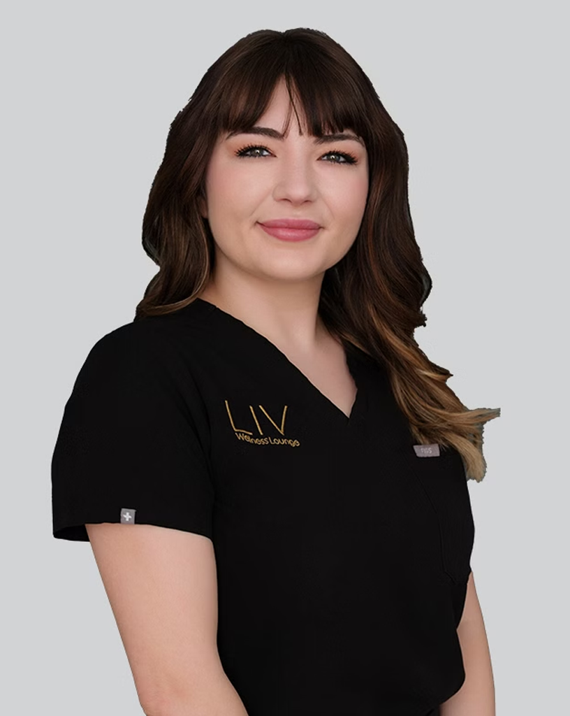 A professional woman named Jessica Rutherford smiles while wearing a LIV Wellness Lounge uniform. She has dark brown hair with bangs and presents a confident and approachable demeanor.