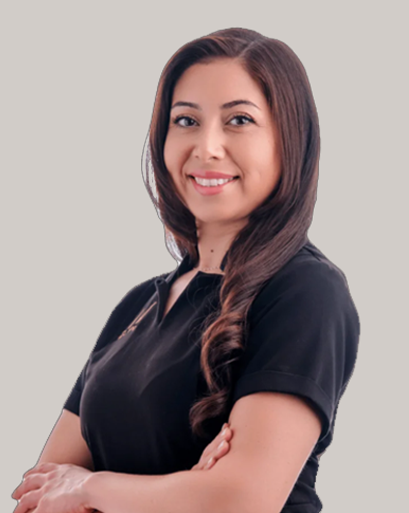 Portrait of Denise smiling confidently, dressed in a black professional uniform.