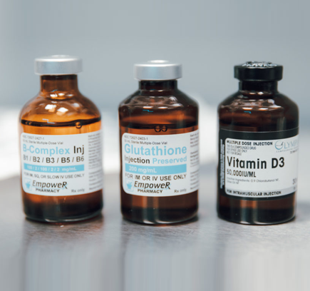 Three amber glass vials containing B-Complex, Glutathione, and Vitamin D3 injections.